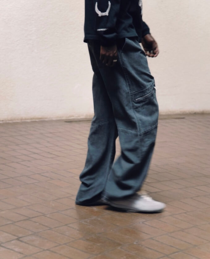 Represent blue denim cargo pants styled with black long sleeve