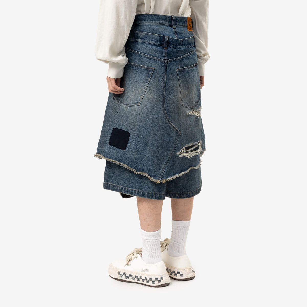 Short en jean superposé réparé