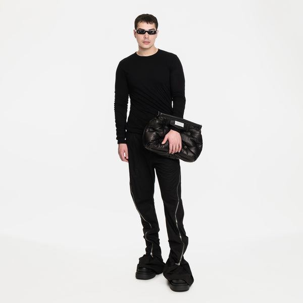 Image 6 of Margiela Glam Slam Classique Medium Bag on model worn with hand through top opening, styled with Rick Owens long sleeve top, bolan banana pants and beatle bogun boots all in black