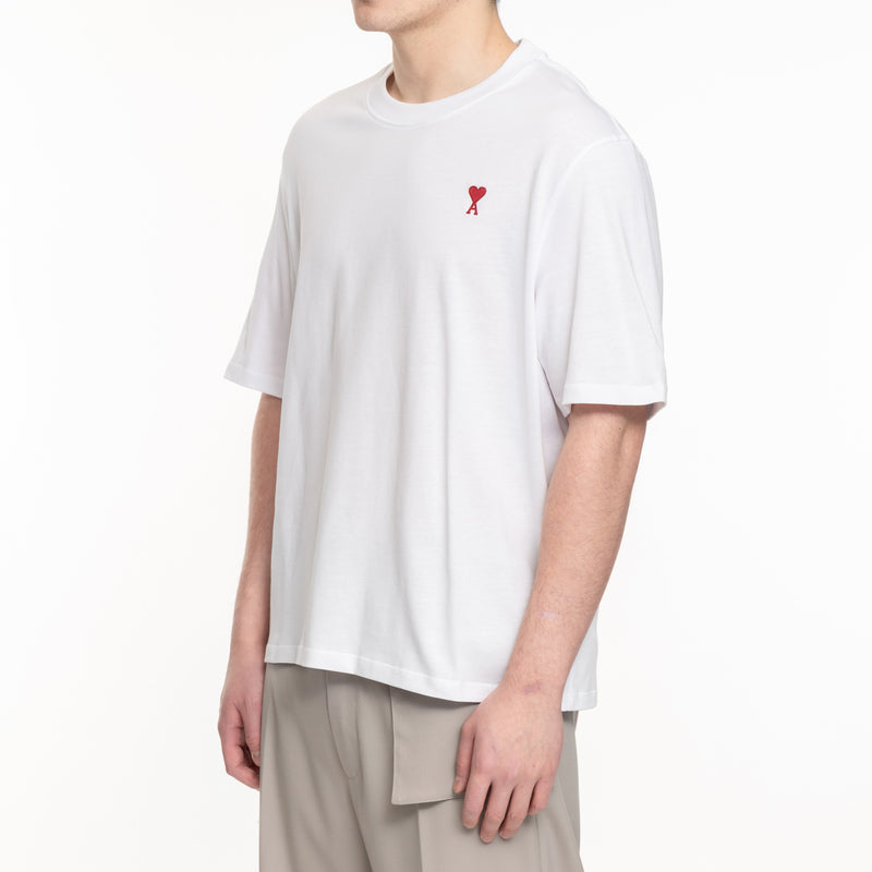 side view of white tshirt with red embroidered logo