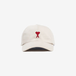 front view of beige cap with embroidered heart logo