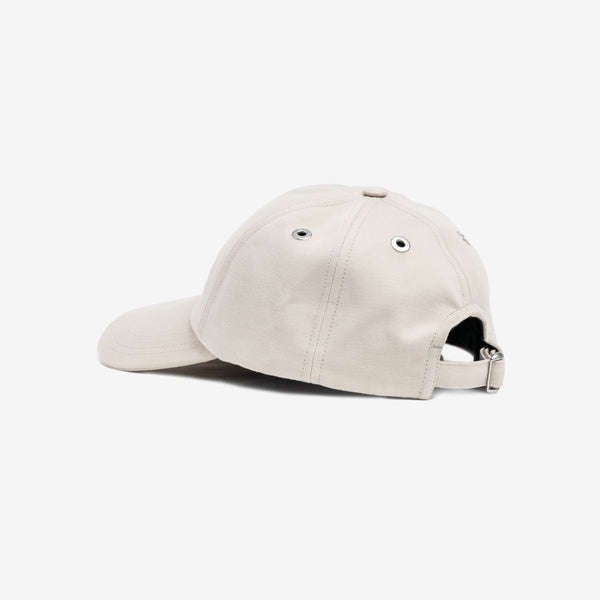 side view of the back of beige cap, adjustable strap