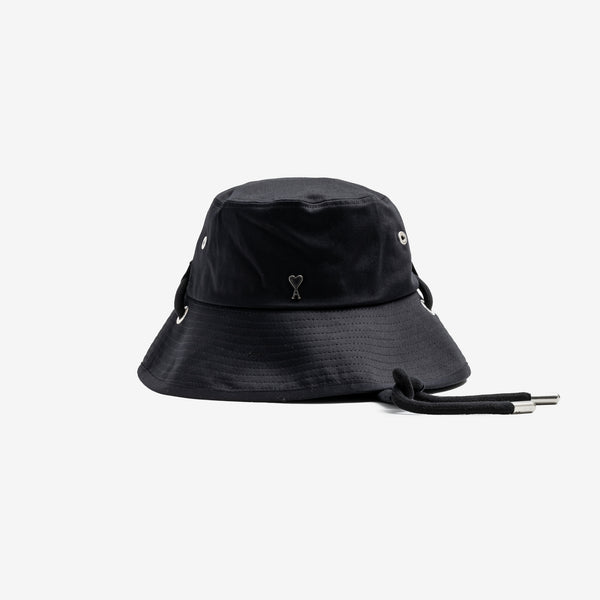 front view of the black bucket hat, small metal AMI heart logo with hat strings
