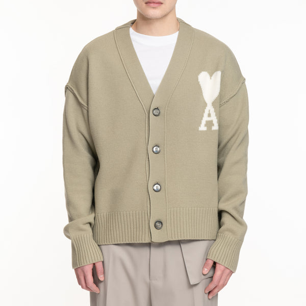 cardigan in sage color with white AMI heart logo, drop shoulder
